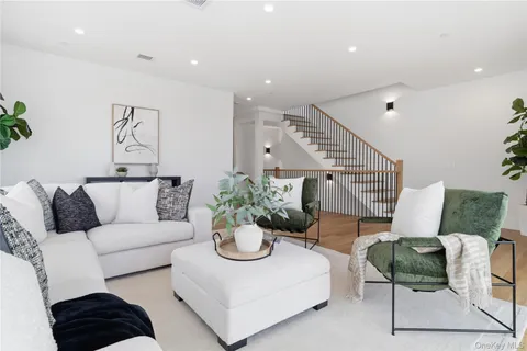a living room with furniture or couch and a potted plant