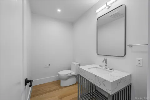 a bathroom with a sink toilet and mirror