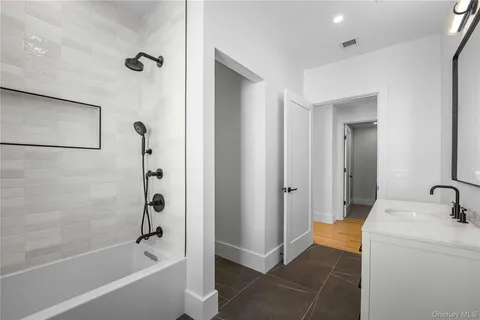 a bathroom with a tub a sink and a shower