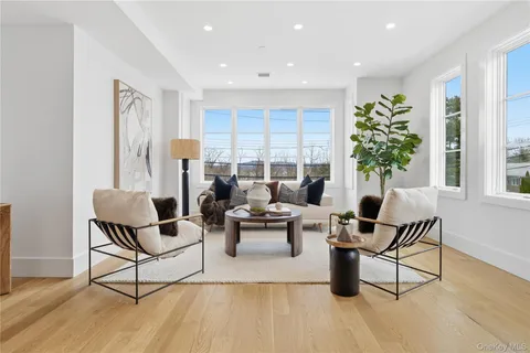 a living room with furniture and floor to ceiling window