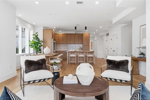 a kitchen with stainless steel appliances a table and chairs