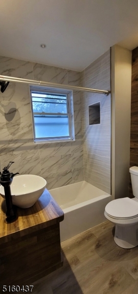 37 Delaware Avenue, Unit 2 Bloomfield, NJ 07003 - Photo 6 of 9 a bathroom with a sink a toilet and shower