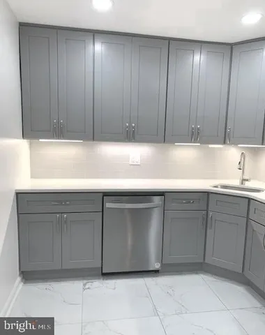 a kitchen with a stove and a sink