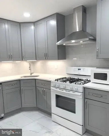 a kitchen with a sink window and cabinets