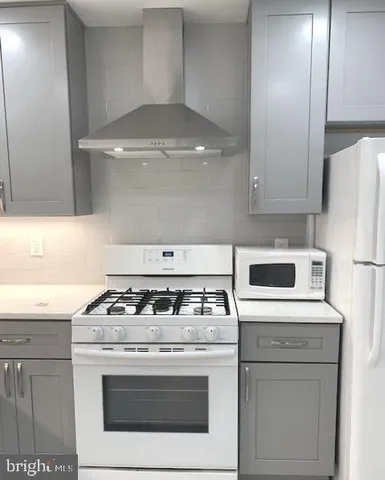a kitchen with a refrigerator a sink and cabinets