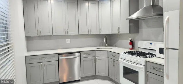 a kitchen with cabinets appliances and a sink