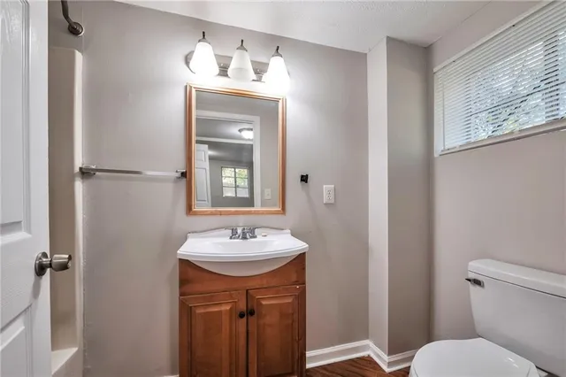 a bathroom with a toilet sink and mirror