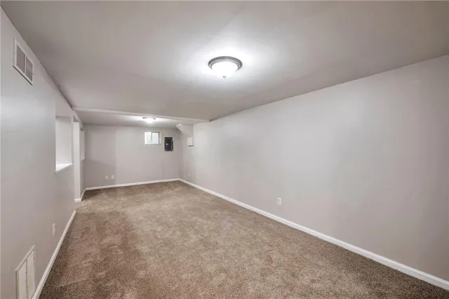 an empty room with a empty space and windows