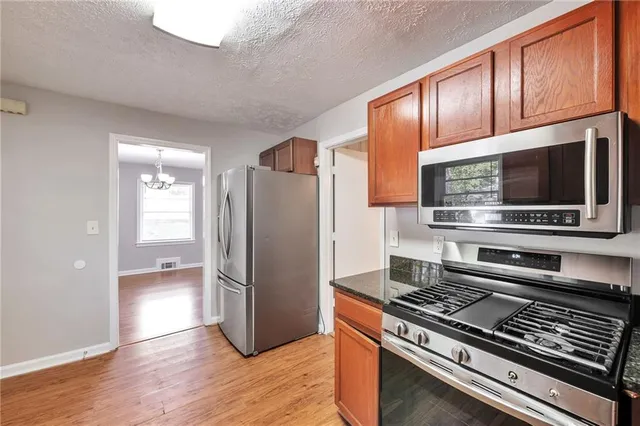 a kitchen with stainless steel appliances and wooden cabinets