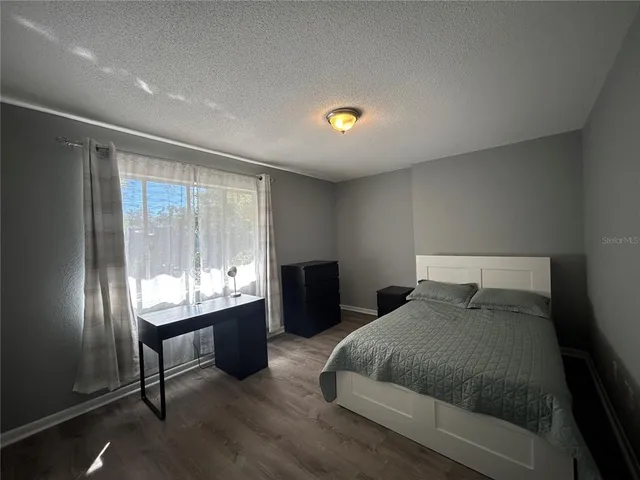 a bedroom with a bed and window