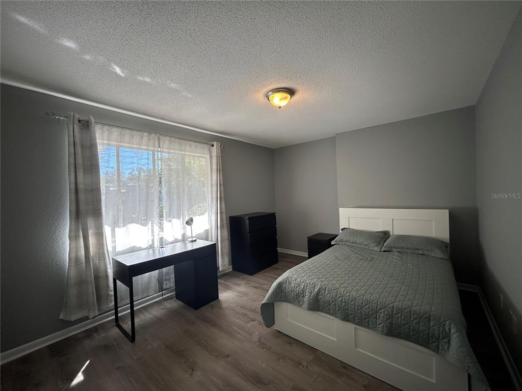 507 Northwest 39th Road, Unit 221 Gainesville, FL 32607 - Photo 12 of 19 a bedroom with a bed and window