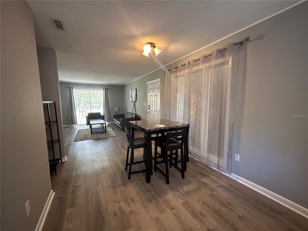 507 Northwest 39th Road, Unit 221 Gainesville, FL 32607 - Photo 18 of 19 a view of a livingroom with furniture window and wooden floor