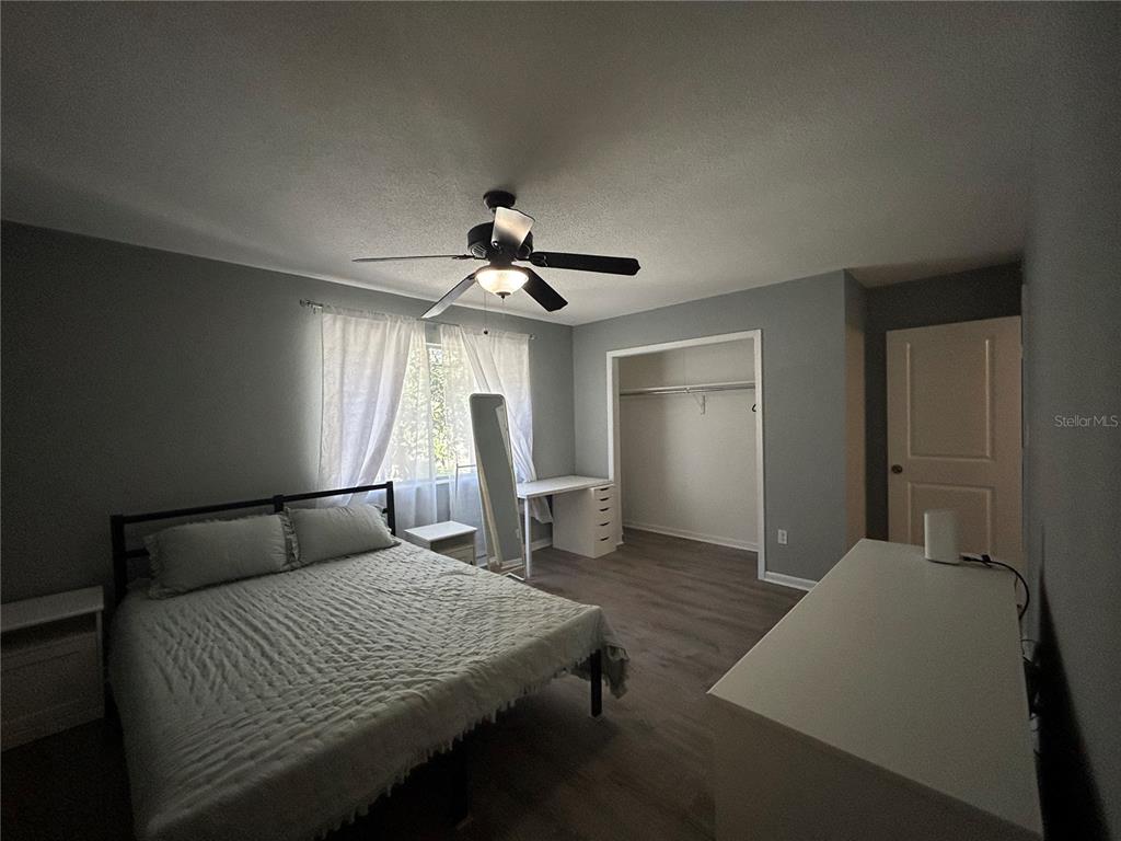 507 Northwest 39th Road, Unit 221 Gainesville, FL 32607 - Photo 7 of 19 a bedroom with a bed and a chandelier