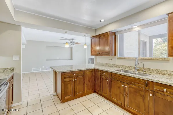 a kitchen with a sink a refrigerator and window
