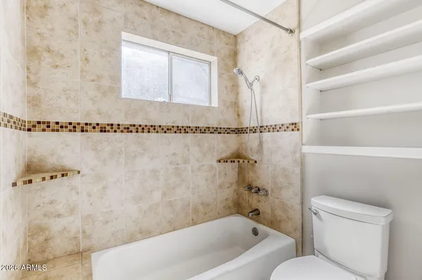 a bathroom with a granite countertop sink a mirror and a shower
