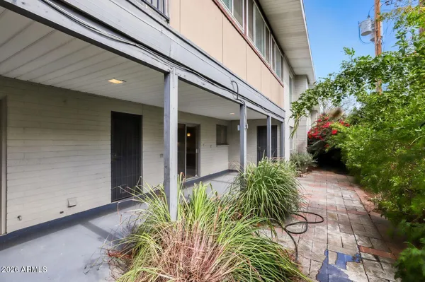 a house with potted plants in front of door