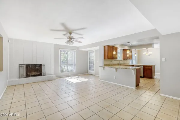 a view of an empty room with a ceiling fan