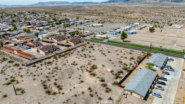 an aerial view of beach and residential houses with outdoor space