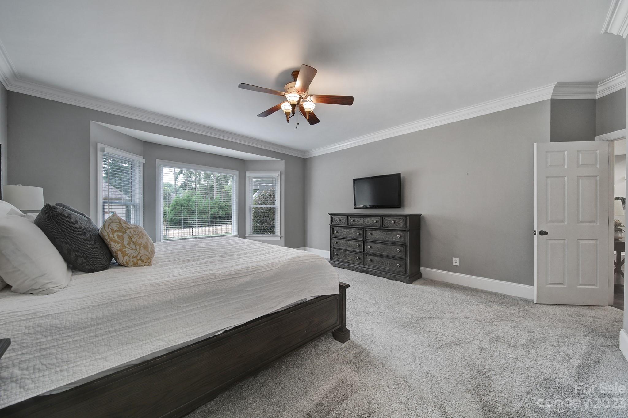 112 Old Post Road Mooresville, NC 28117 - Photo 13 of 42 a spacious bedroom with a bed and a television