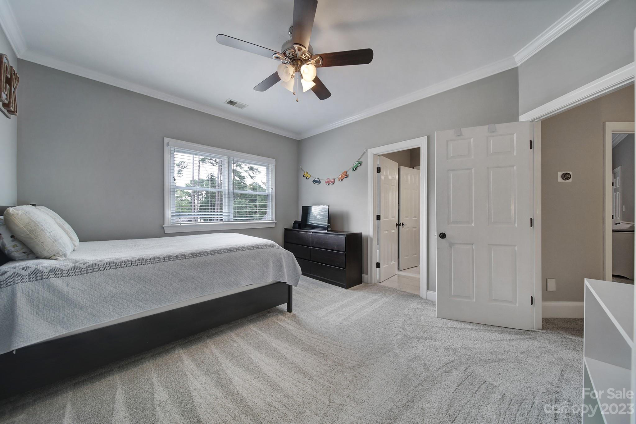 112 Old Post Road Mooresville, NC 28117 - Photo 21 of 42 a spacious bedroom with a bed a dresser and a chandelier