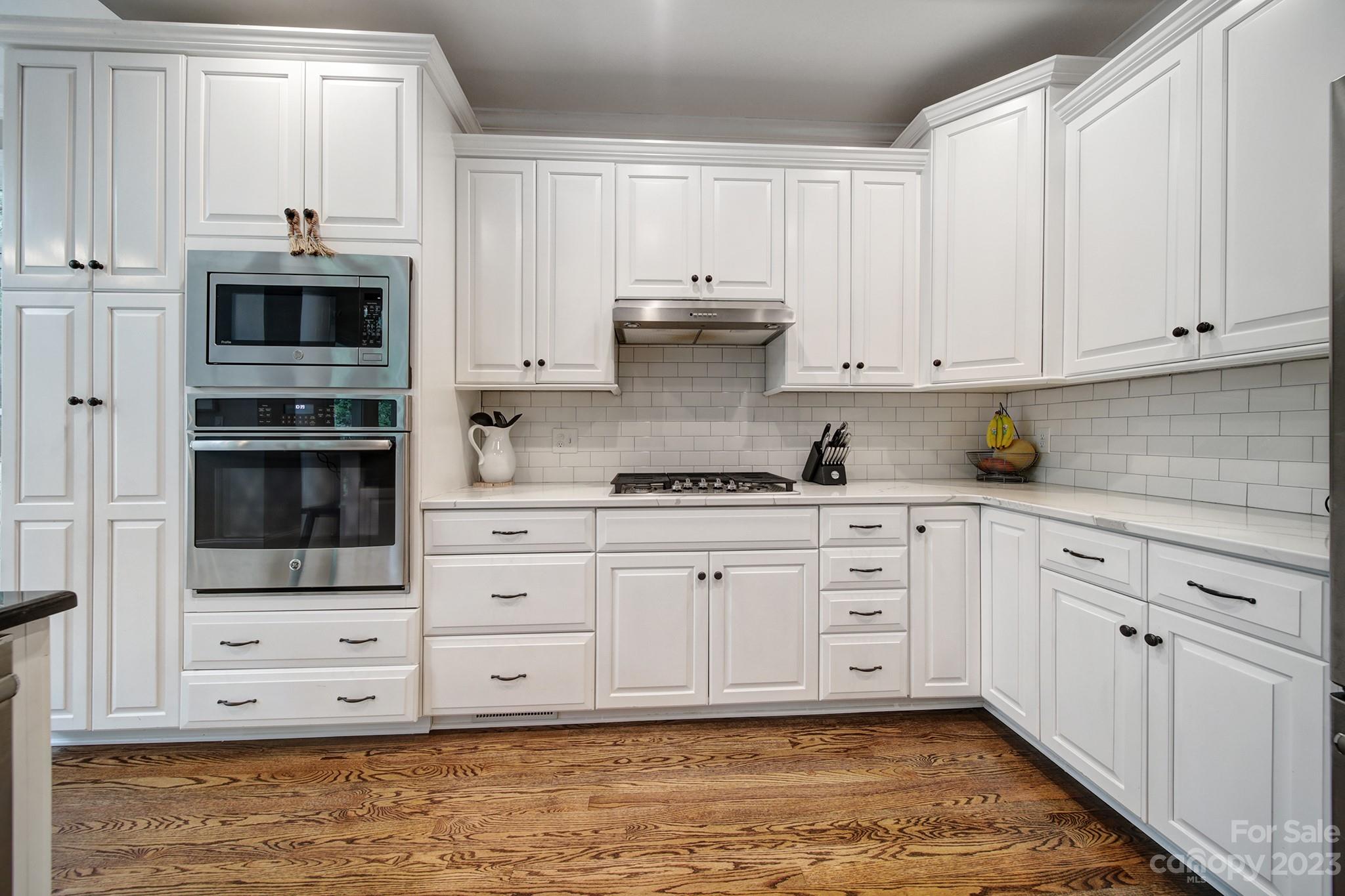 112 Old Post Road Mooresville, NC 28117 - Photo 4 of 42 a kitchen with stainless steel appliances granite countertop a stove a sink and white cabinets