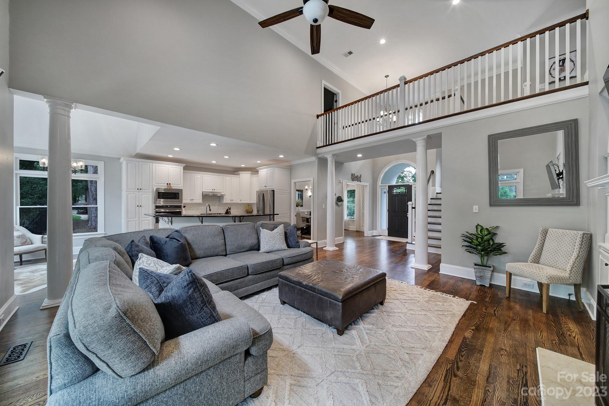 112 Old Post Road Mooresville, NC 28117 - Photo 7 of 42 a living room with furniture kitchen view and a wooden floor