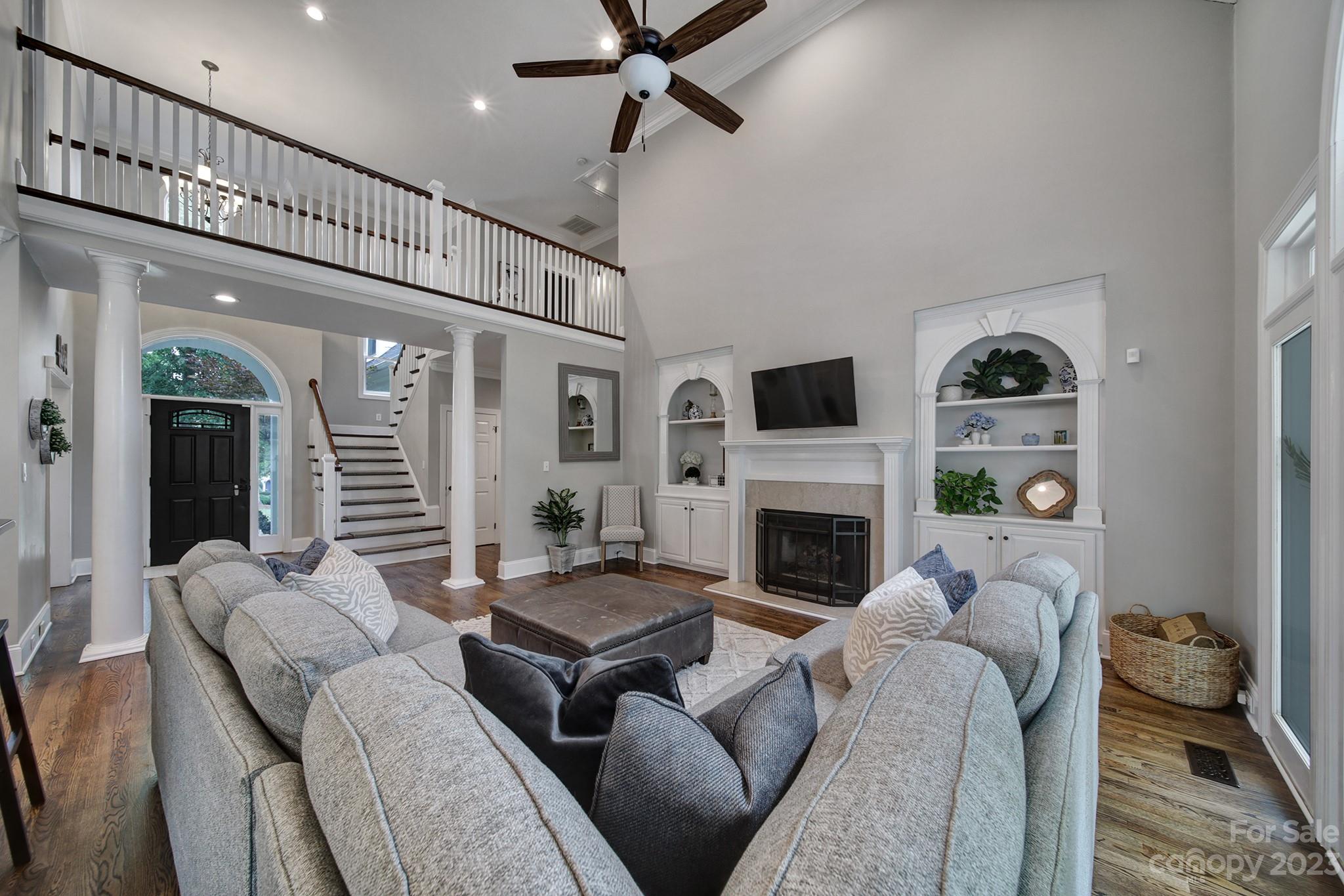 112 Old Post Road Mooresville, NC 28117 - Photo 8 of 42 a living room with furniture a fireplace and a flat screen tv