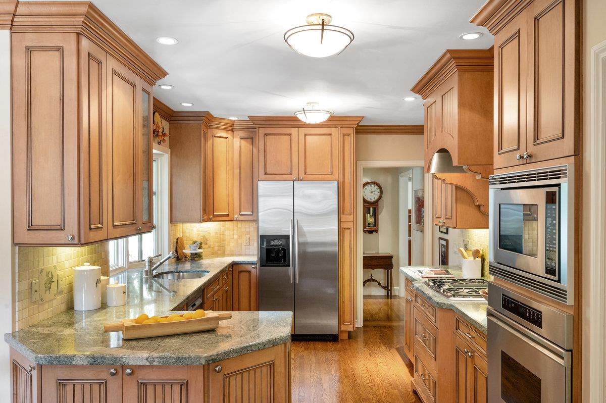 549 Edgewood Road San Mateo, CA 94402 - Photo 14 of 44 a kitchen with stainless steel appliances granite countertop a refrigerator a oven and white cabinets with wooden floors