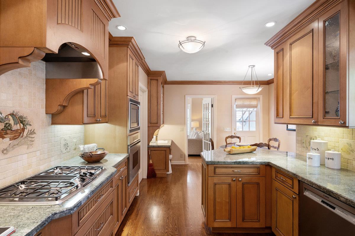 549 Edgewood Road San Mateo, CA 94402 - Photo 16 of 44 a kitchen with a sink stove and cabinets