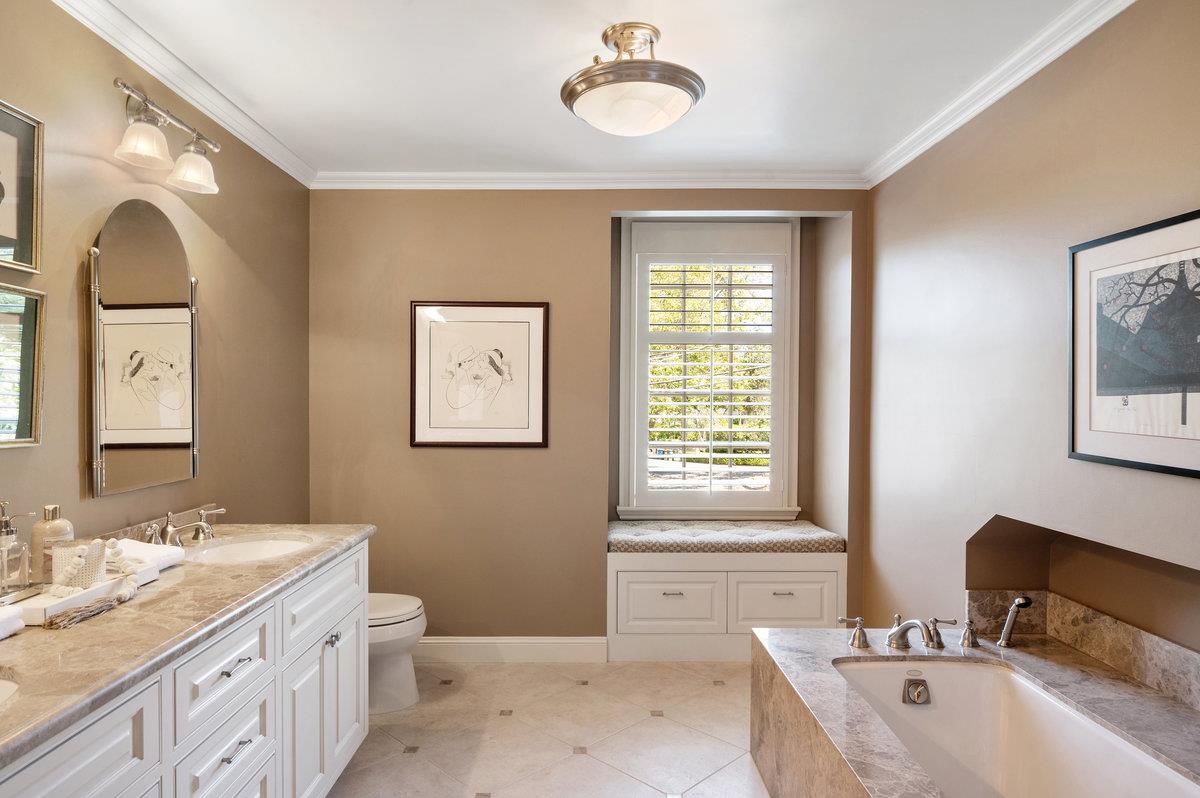 549 Edgewood Road San Mateo, CA 94402 - Photo 24 of 44 a spacious bathroom with a granite countertop tub a double vanity sink and a window