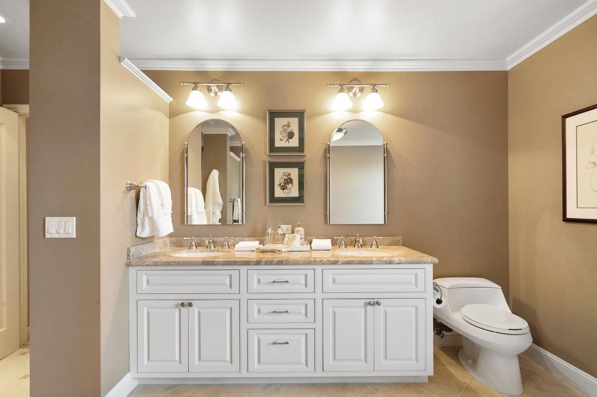 549 Edgewood Road San Mateo, CA 94402 - Photo 25 of 44 a bathroom with a toilet a double vanity sink and a mirror