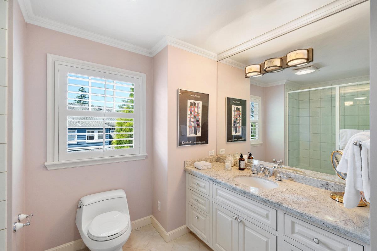 549 Edgewood Road San Mateo, CA 94402 - Photo 31 of 44 a bathroom with a granite countertop sink toilet a large mirror and a window