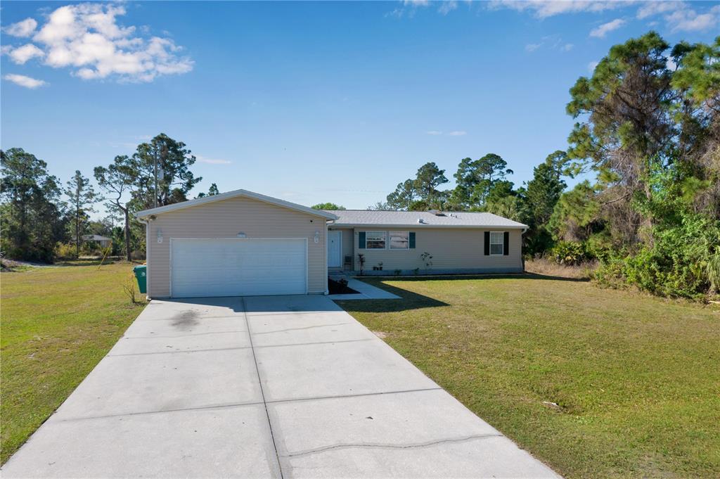 26307 Glaspell Road Punta Gorda, FL 33955 - Photo 1 of 1 a front view of house with yard and trees in the background
