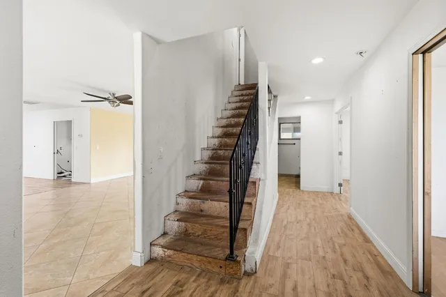 a view of a hallway with wooden floor and entryway