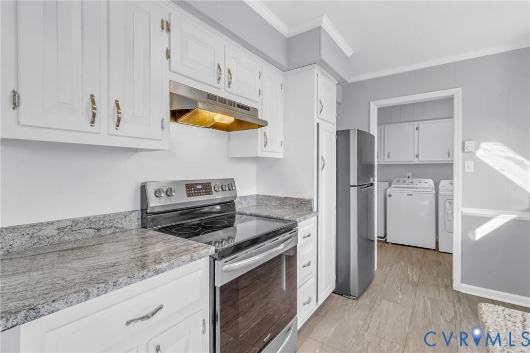 1928 Lake Road Lottsburg, VA 22511 - Photo 12 of 47 a kitchen with stainless steel appliances granite countertop a refrigerator stove and white cabinets