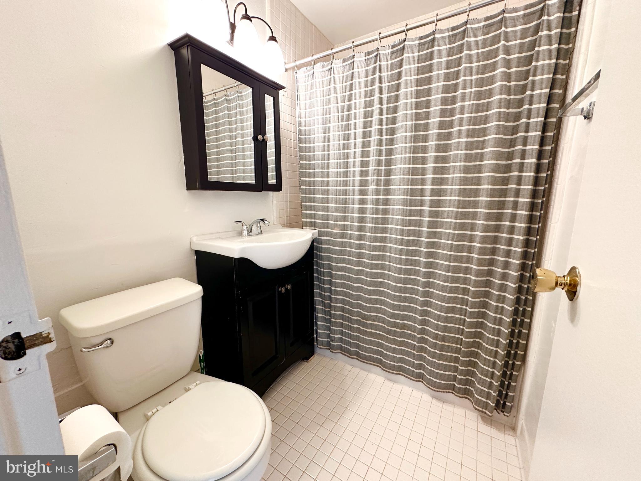 1111 Arlington Boulevard, Unit 615 Arlington, VA 22209 - Photo 12 of 37 a bathroom with a toilet sink and mirror