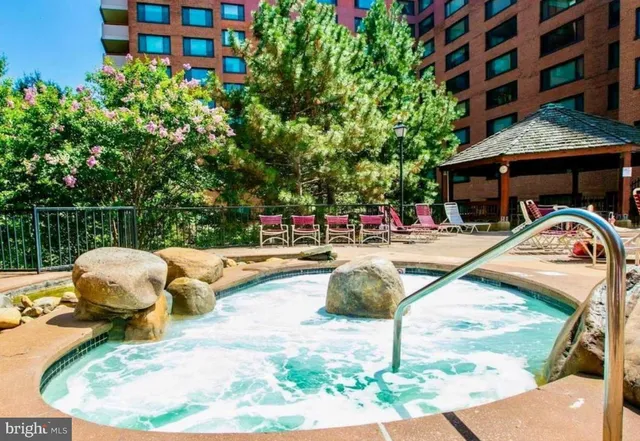 a view of swimming pool with a lounge chairs