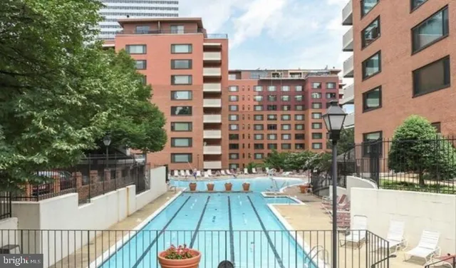 a view of a swimming pool with outdoor seating and plants