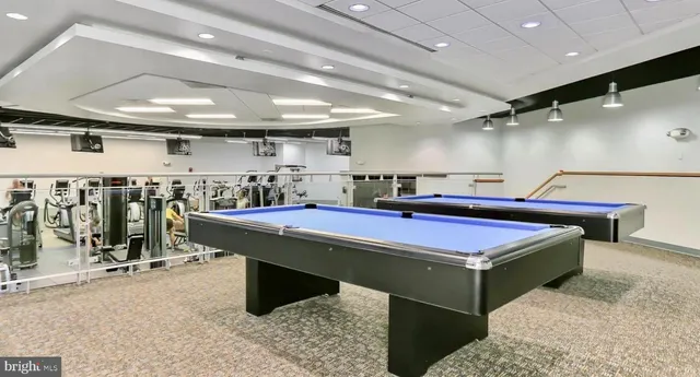a room with pool table and lots of wooden furniture