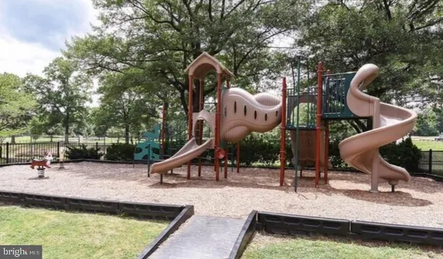 a view of a swimming pool with a patio and fire pit