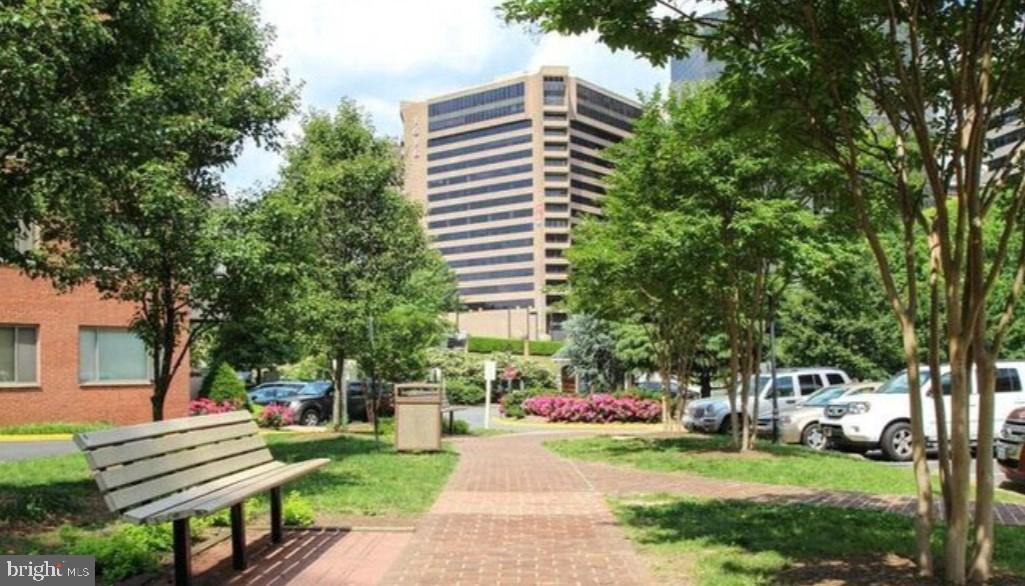 1111 Arlington Boulevard, Unit 615 Arlington, VA 22209 - Photo 31 of 37 a front view of a house with a yard and a garden