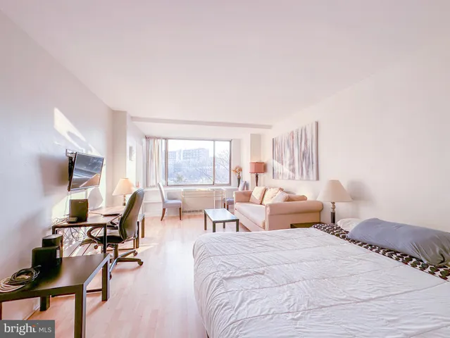 a bedroom with furniture and wooden floor
