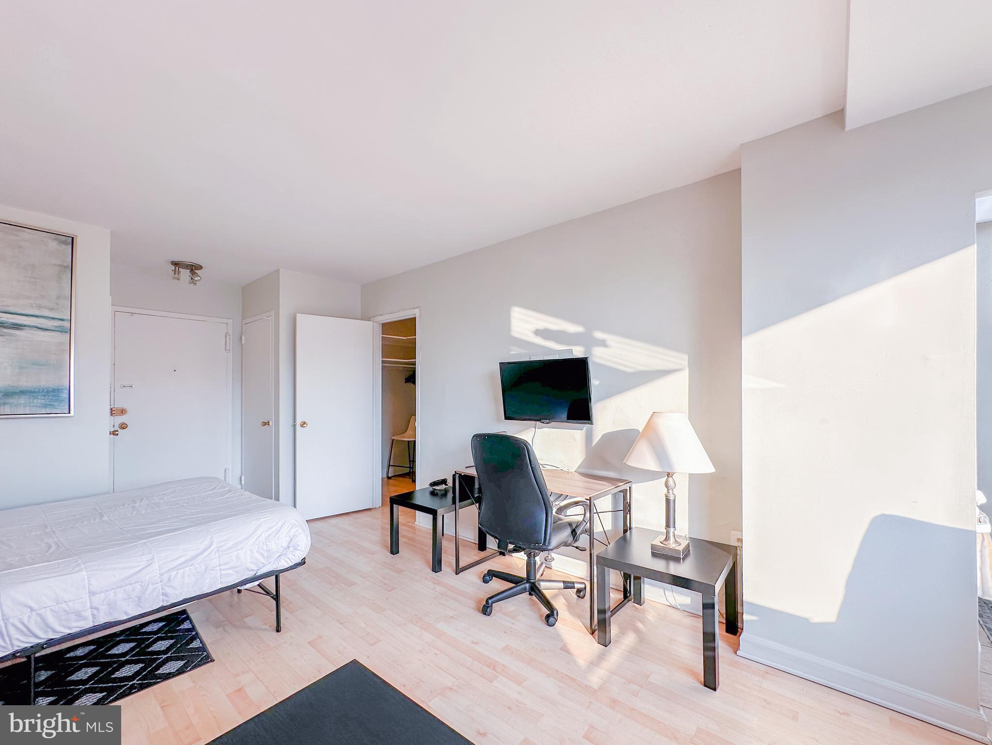 1111 Arlington Boulevard, Unit 615 Arlington, VA 22209 - Photo 8 of 37 a living room with furniture and a table