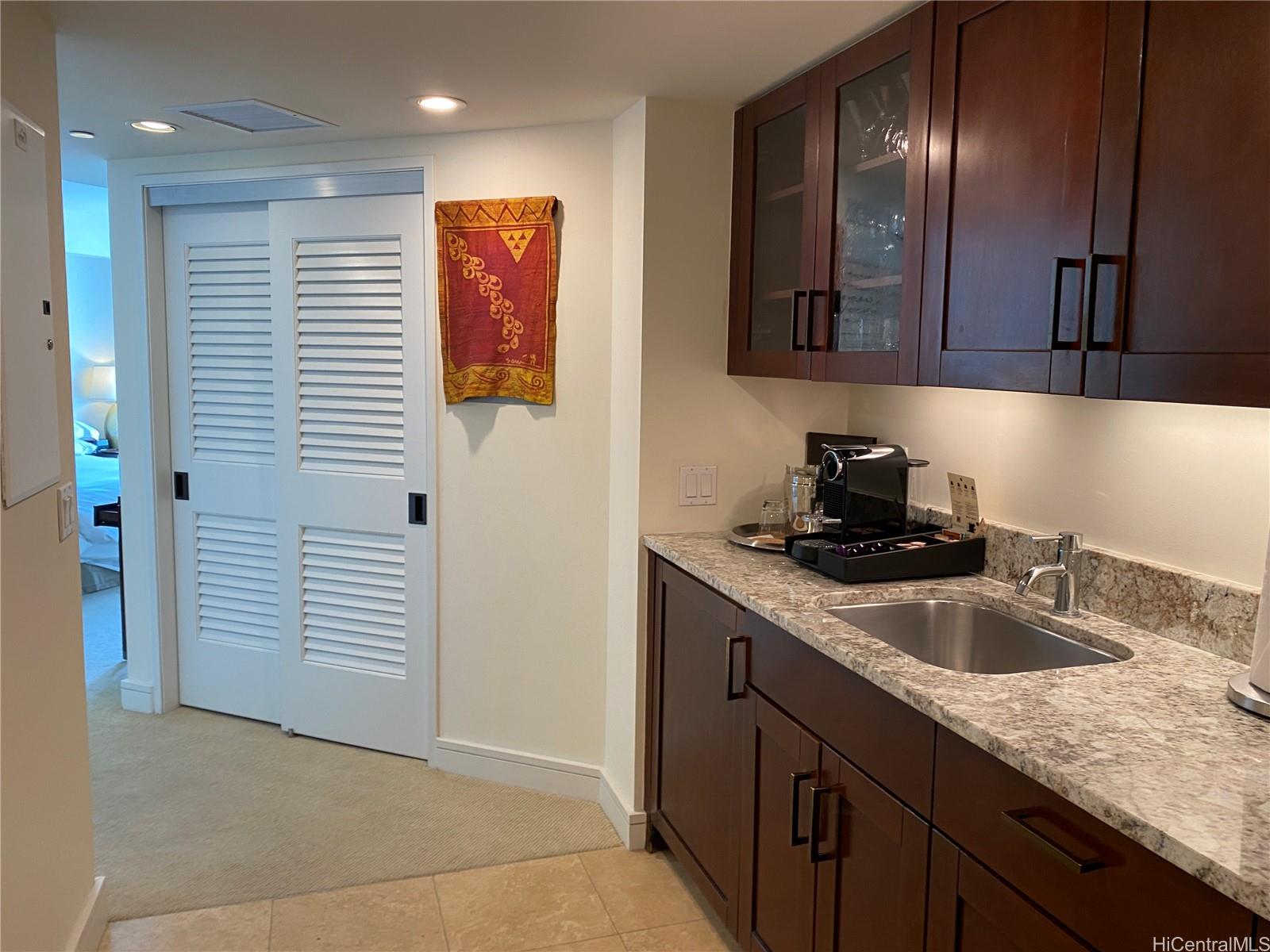 223 Saratoga Road, Unit 2316 Honolulu, HI 96815 - Photo 8 of 20 a kitchen with a sink and cabinets