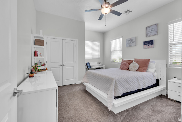 6105 Bunda Way St. George, UT 84790 - Photo 15 of 49 Vaulted ceiling with a ceiling fan, dual windows with blinds, built-in shelving, and white bi-fold closet doors