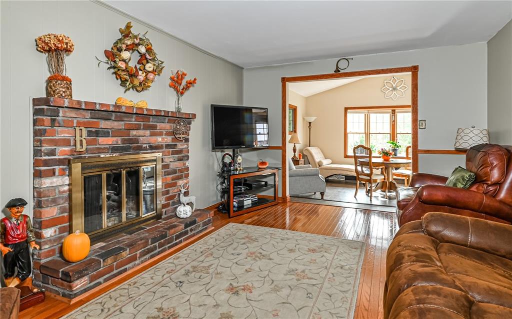 463 Inwood Road Pittsburgh, PA 15237 - Photo 15 of 47 a living room with furniture a flat screen tv and a fireplace
