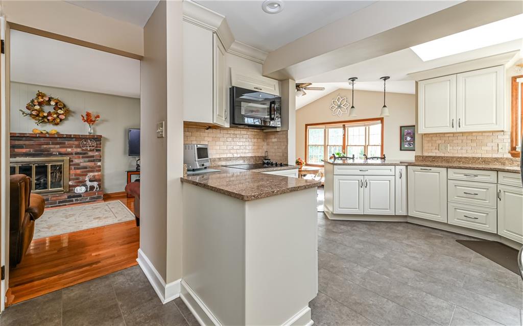 463 Inwood Road Pittsburgh, PA 15237 - Photo 6 of 47 a kitchen with granite countertop cabinets a sink a window and stainless steel appliances