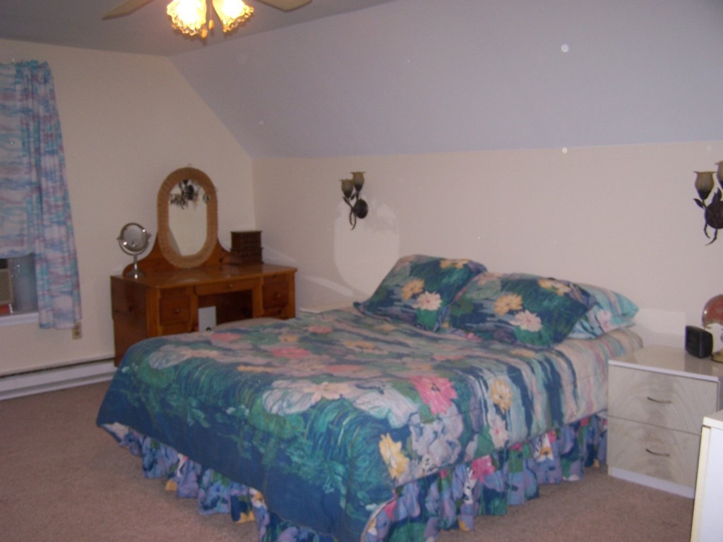 1388 Brimfield Road Warren, MA 01010 - Photo 13 of 21 a bedroom with a bed and a chandelier