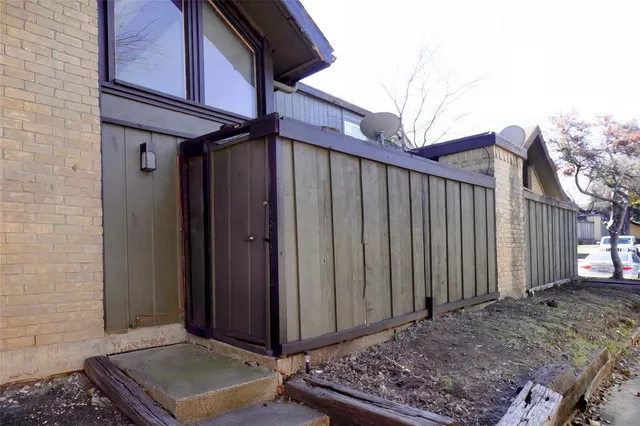 a view of a house with a wooden fence