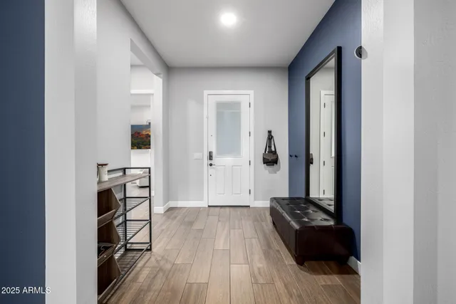 a view of a hallway with wooden floor